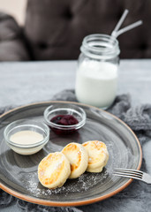Curd pancakes with berry jam and sour cream