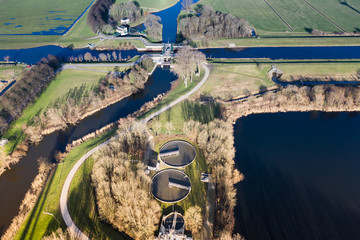 A dutch water treatment plant for cleaning the sewage water, seen from above during sunset. Near Waalwijk, Noord-Brabant, Netherlands.
