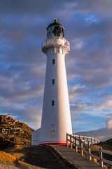 Naklejka premium Panoramic scenic landscape view of the Castlepoint lighthouse in sunrise colours, white landmark, tourist popular attraction/destination in North Island, New Zealand. 