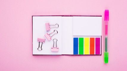 Pink background stickers, paper clips, highlighter. Minimalist blank for office, business, school project. Horizontal,