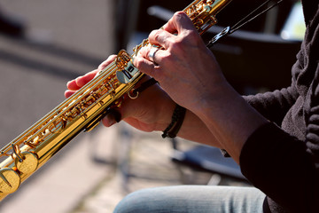 Fragment of the hands of an old street musician. An image of the hands of a musician male pressing...
