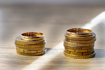 a ray of light between wedding rings, on coins