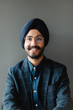 Portrait of smiling Indian sikh man wearing turban looking at camera.