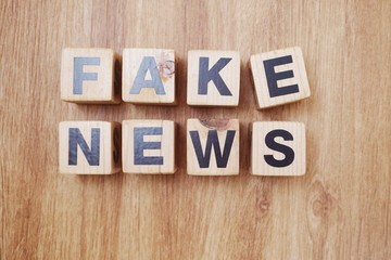 Fake News word alphabet letters on wooden background