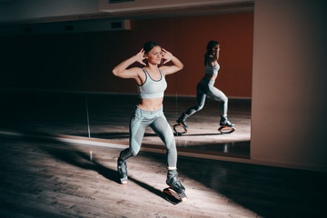 Smiling young sporty Caucasian brunette doing exercises with kangoo jumps footwear.