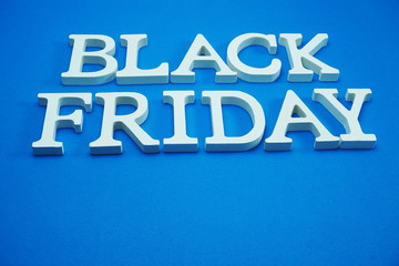 Black Friday sale shopping concept alphabet on blue background