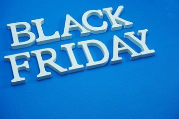 Black Friday sale shopping concept alphabet on blue background