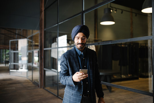 Smiling businessman using smartphone in office