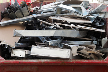 Construction waste in a large tank. Metal and Drywall