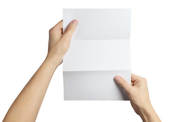 Fototapeta premium Hands holding a folded sheet of white paper, isolated on white background