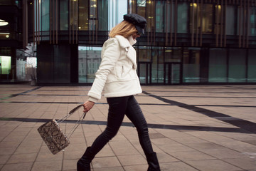 Stylish and elegant young woman on the background of the business center.