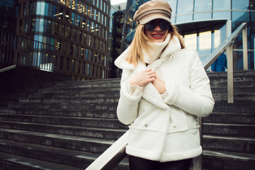 Stylish and elegant young woman on the background of the business center.