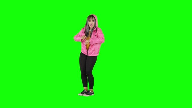 Attractive female modern style dancer performing in the studio. Shot in 4k resolution with green screen background