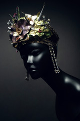Head of mannequin in creative kokoshnick with flower and leaves