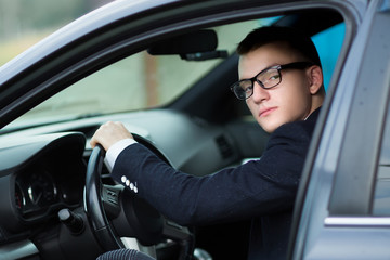 Obraz na płótnie Canvas close up.successful young businessman sitting behind the wheel of a car.