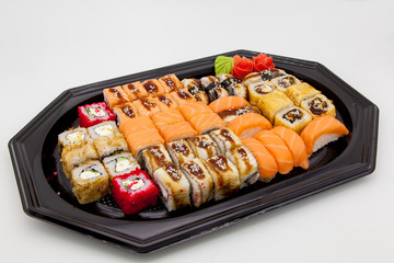 Japanese traditional cuisine, ready-made rolls and sushi in the package, on a white background, for the application and design of fast-food