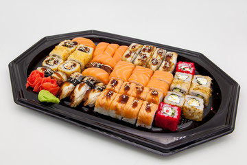Japanese traditional cuisine, ready-made rolls and sushi in the package, on a white background, for the application and design of fast-food