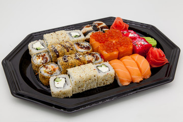 Japanese traditional cuisine, ready-made rolls and sushi in the package, on a white background, for the application and design of fast-food