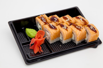 Japanese traditional cuisine, ready-made rolls and sushi in the package, on a white background, for the application and design of fast-food