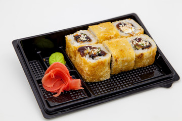 Japanese traditional cuisine, ready-made rolls and sushi in the package, on a white background, for the application and design of fast-food