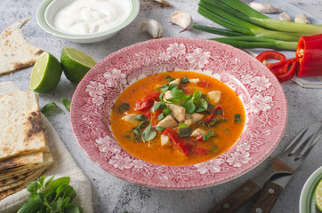 Spicy curry with homemade tortilla and garlic dip