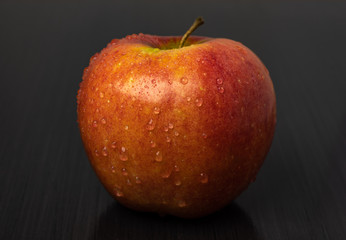 Red apple on black background