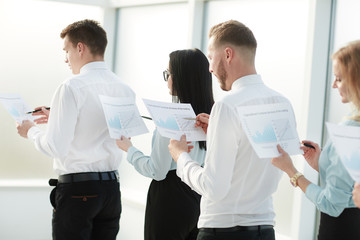 close up. employees with financial reports standing in line
