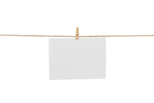 White blank photo card hanging on clothesline. 