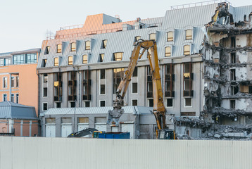 Cleaning of construction debris with a bucket of an excavator, the excavator loads the remains of...
