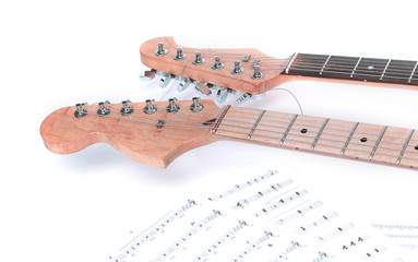closeup .sheet music and guitar on a white background.
