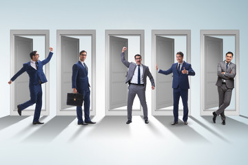 Fototapeta premium Businessman in uncertainty concept with many doors