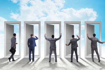 Fototapeta premium Businessman in uncertainty concept with many doors