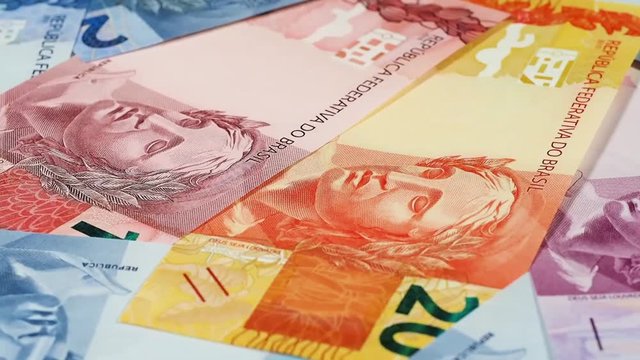 Brazil real notes slow rotating.  Close up, low angle. Brazilian money, currency. Stock video footage