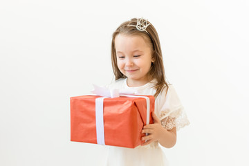 Holiday and presents concept- Little girl smile and holding red gift box
