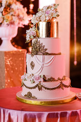 Closeup of white wedding cake with flowers. Big wedding cake. Decor trends. Wedding ceremony.