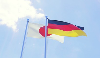 Japan and Germany, two flags waving against blue sky. 3d image