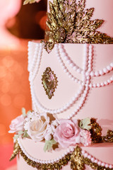 Closeup of white wedding cake with flowers. Big wedding cake. Decor trends. Wedding ceremony.