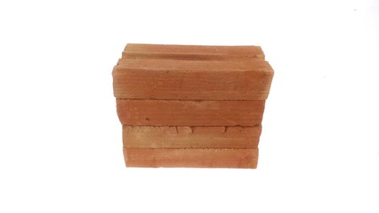 Small red bricks for construction with white background.