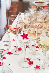 glasses of champagne and confetti on a white table