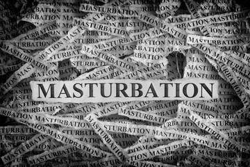Torn pieces of paper with the words Masturbation