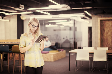 blonde businesswoman working online using digital tablet