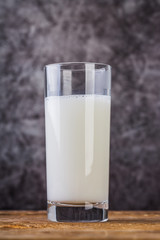 Glass of milk on wooden table