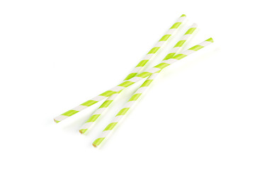 Green stripped paper straws on white