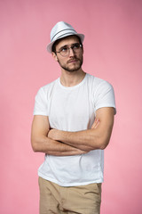 Portrait of the young thinking man looks up - isolated on pink