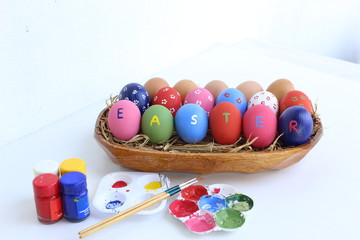 easter eggs in basket on wooden background