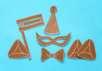Purim celebration concept (jewish carnival holiday). Traditional symbols shapes cutted from paper