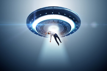 Flying saucer abducting young businessman 