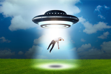 Flying saucer abducting young businessman 