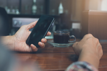 Man using smartphone at coffee shop