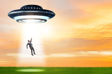 Flying saucer abducting young businessman 